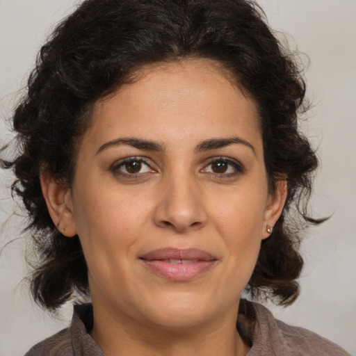 Joyful white adult female with medium  brown hair and brown eyes