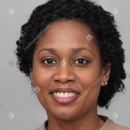 Joyful black adult female with short  brown hair and brown eyes