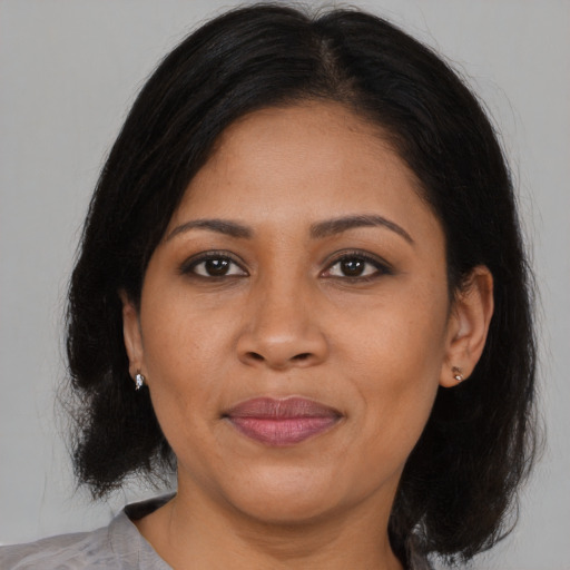 Joyful asian young-adult female with medium  brown hair and brown eyes