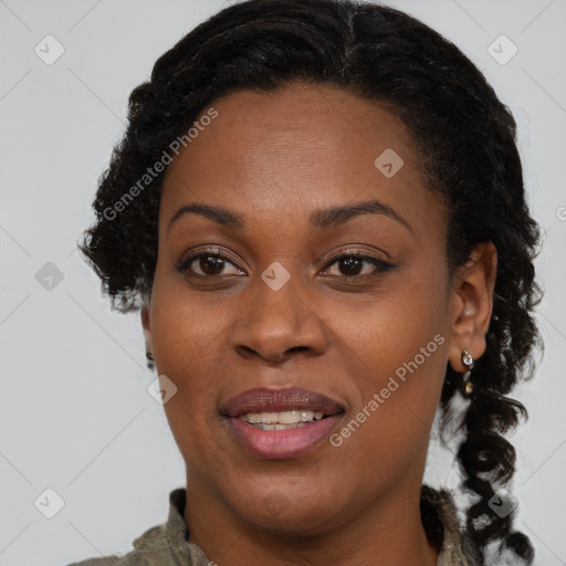 Joyful black adult female with medium  brown hair and brown eyes