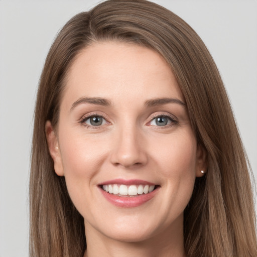 Joyful white young-adult female with long  brown hair and grey eyes