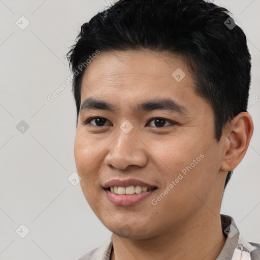 Joyful asian young-adult male with short  black hair and brown eyes