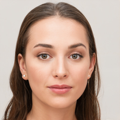 Joyful white young-adult female with long  brown hair and grey eyes