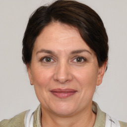 Joyful white adult female with medium  brown hair and brown eyes