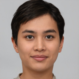 Joyful asian young-adult male with short  brown hair and brown eyes