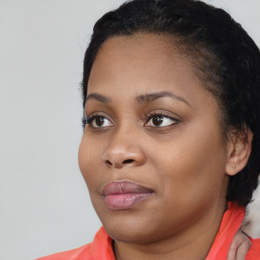 Joyful black young-adult female with medium  black hair and brown eyes