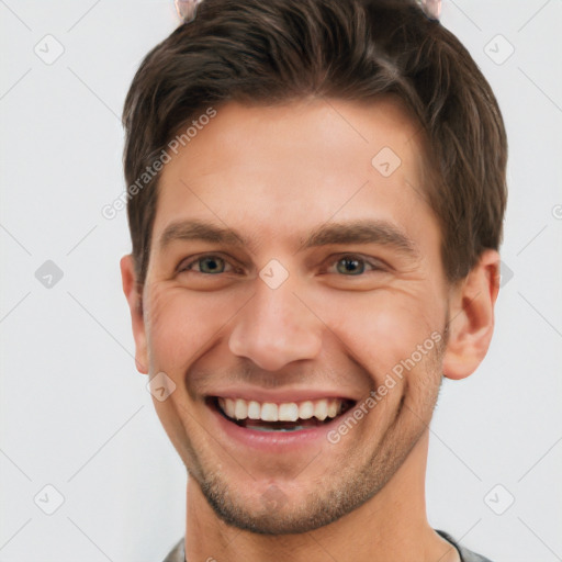 Joyful white young-adult male with short  brown hair and grey eyes