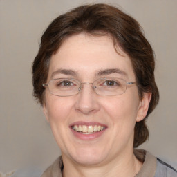 Joyful white adult female with medium  brown hair and grey eyes