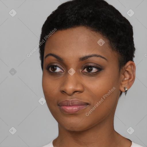 Joyful black young-adult female with short  black hair and brown eyes