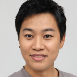 Joyful asian young-adult male with short  black hair and brown eyes