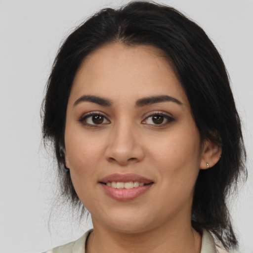 Joyful latino young-adult female with medium  black hair and brown eyes