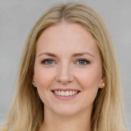 Joyful white young-adult female with long  brown hair and blue eyes