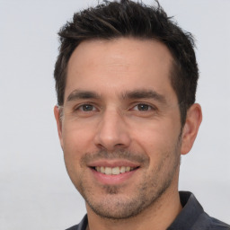 Joyful white young-adult male with short  brown hair and brown eyes