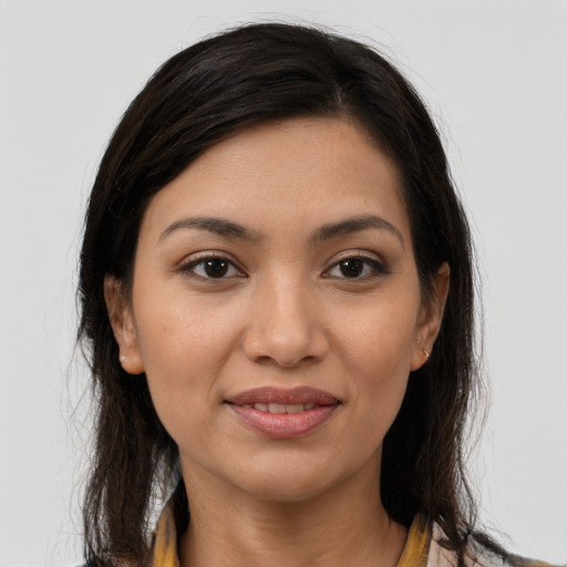 Joyful latino young-adult female with long  brown hair and brown eyes