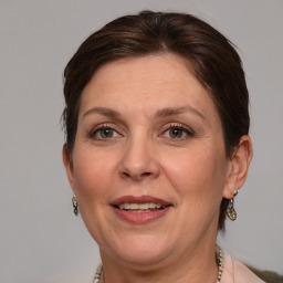 Joyful white adult female with medium  brown hair and grey eyes