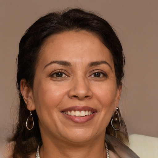 Joyful white adult female with medium  brown hair and brown eyes