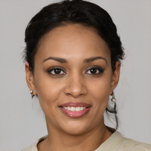 Joyful latino young-adult female with short  brown hair and brown eyes