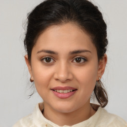 Joyful latino young-adult female with medium  brown hair and brown eyes