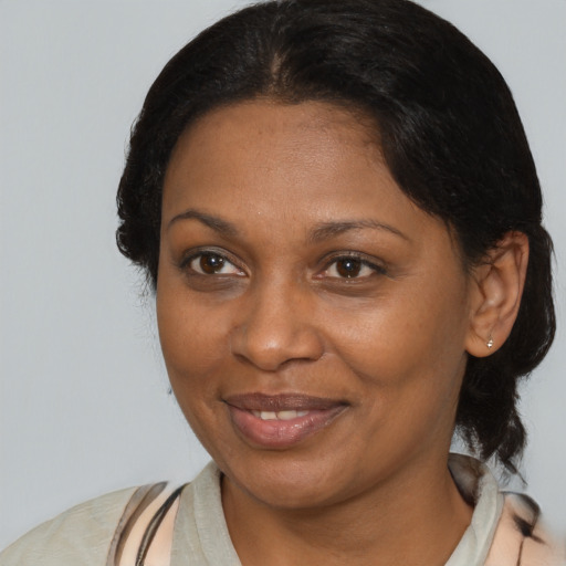 Joyful black adult female with medium  brown hair and brown eyes