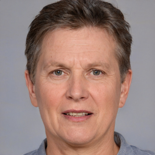 Joyful white middle-aged male with short  brown hair and grey eyes