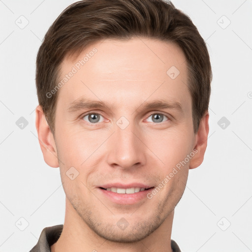 Joyful white young-adult male with short  brown hair and grey eyes