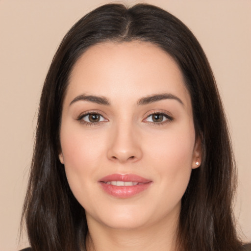 Joyful white young-adult female with long  brown hair and brown eyes