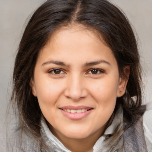 Joyful white young-adult female with medium  brown hair and brown eyes
