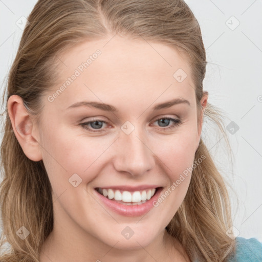 Joyful white young-adult female with long  brown hair and blue eyes