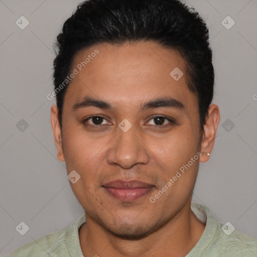 Joyful latino young-adult male with short  black hair and brown eyes