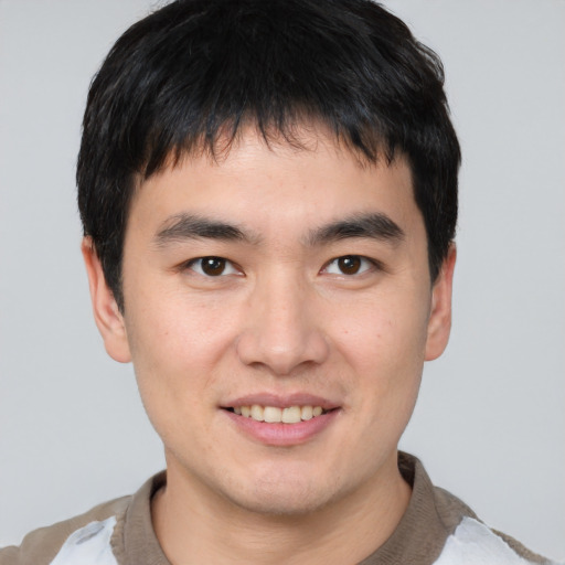 Joyful asian young-adult male with short  brown hair and brown eyes