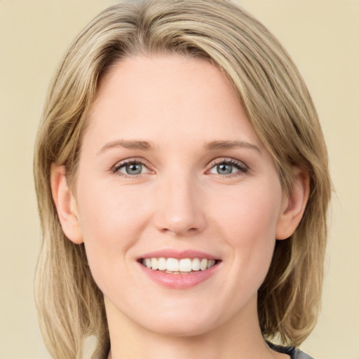 Joyful white young-adult female with medium  brown hair and green eyes