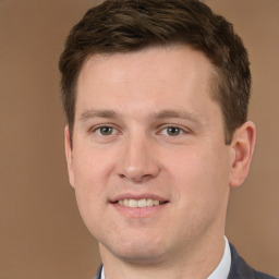 Joyful white young-adult male with short  brown hair and brown eyes