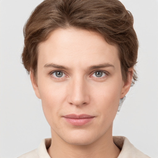 Joyful white young-adult female with short  brown hair and grey eyes