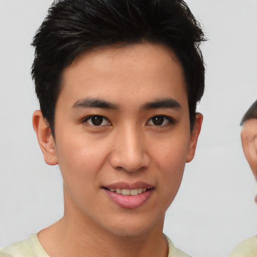 Joyful asian young-adult male with short  brown hair and brown eyes