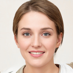 Joyful white young-adult female with medium  brown hair and blue eyes