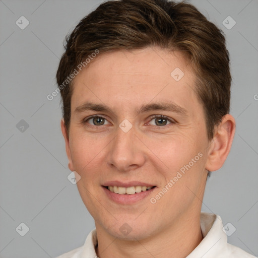 Joyful white young-adult male with short  brown hair and grey eyes