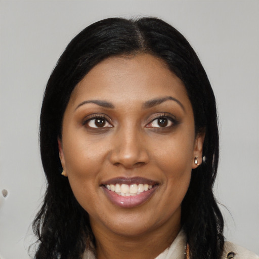 Joyful latino young-adult female with long  black hair and brown eyes