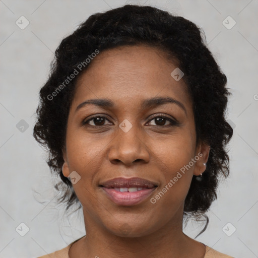 Joyful black adult female with medium  brown hair and brown eyes