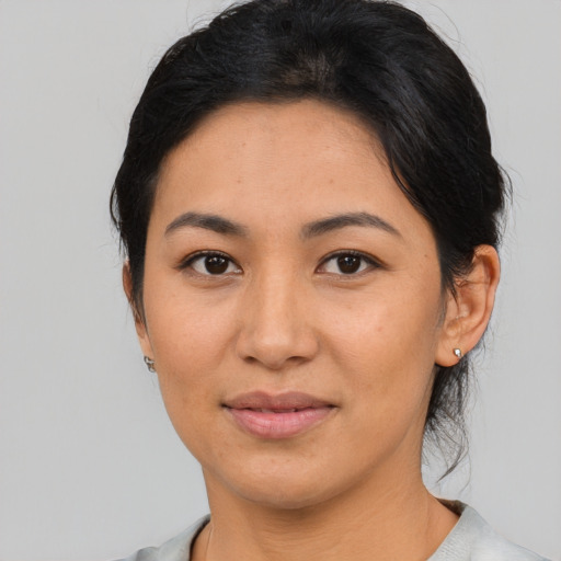 Joyful asian young-adult female with medium  brown hair and brown eyes