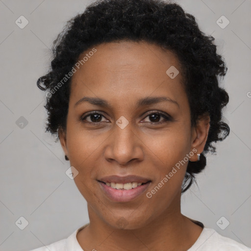 Joyful black young-adult female with short  black hair and brown eyes