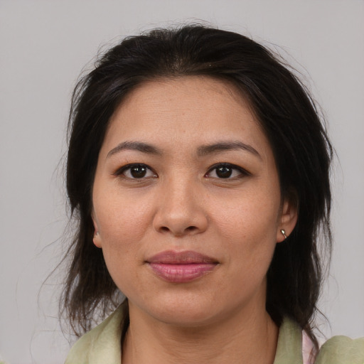 Joyful asian adult female with medium  brown hair and brown eyes