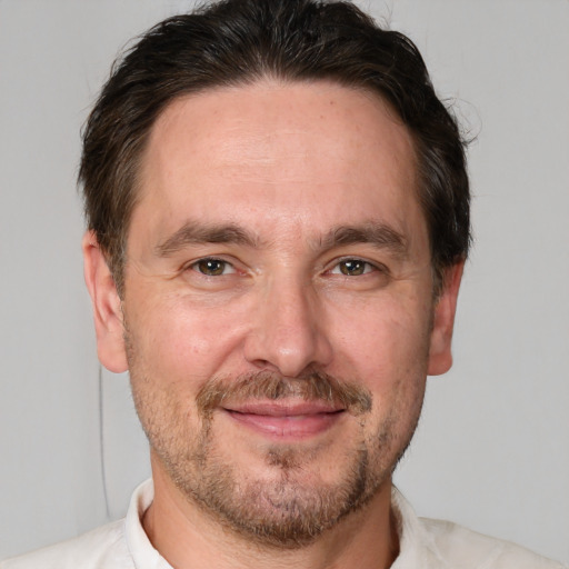 Joyful white adult male with short  brown hair and brown eyes