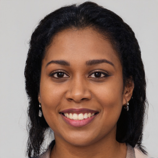 Joyful latino young-adult female with long  black hair and brown eyes