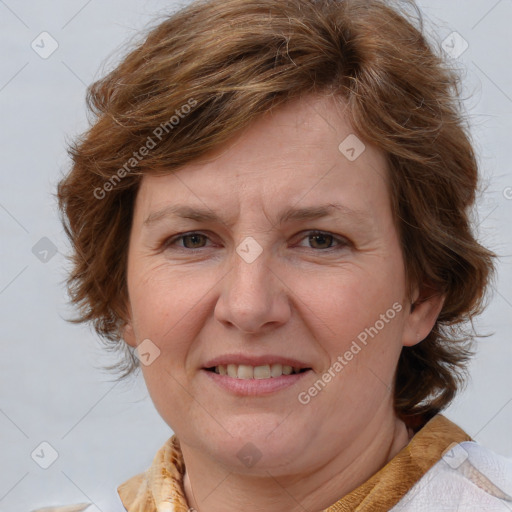 Joyful white adult female with medium  brown hair and blue eyes