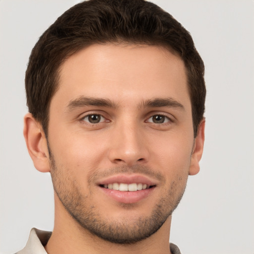 Joyful white young-adult male with short  brown hair and brown eyes