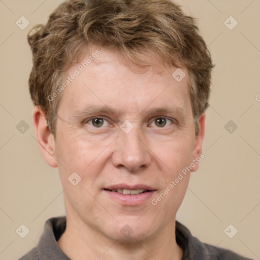 Joyful white adult male with short  brown hair and grey eyes