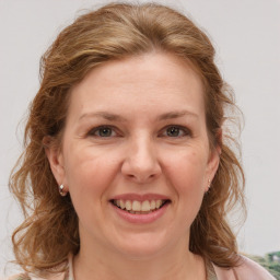 Joyful white adult female with medium  brown hair and grey eyes