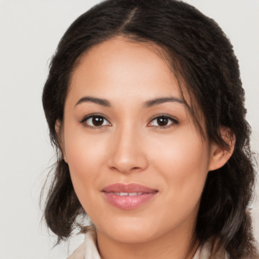 Joyful latino young-adult female with medium  brown hair and brown eyes