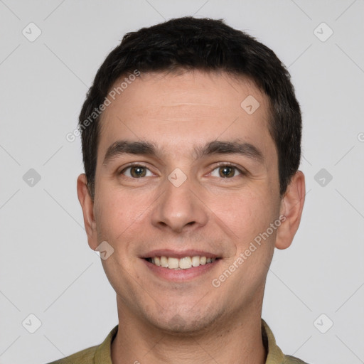 Joyful white young-adult male with short  black hair and brown eyes