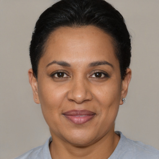 Joyful latino adult female with short  black hair and brown eyes